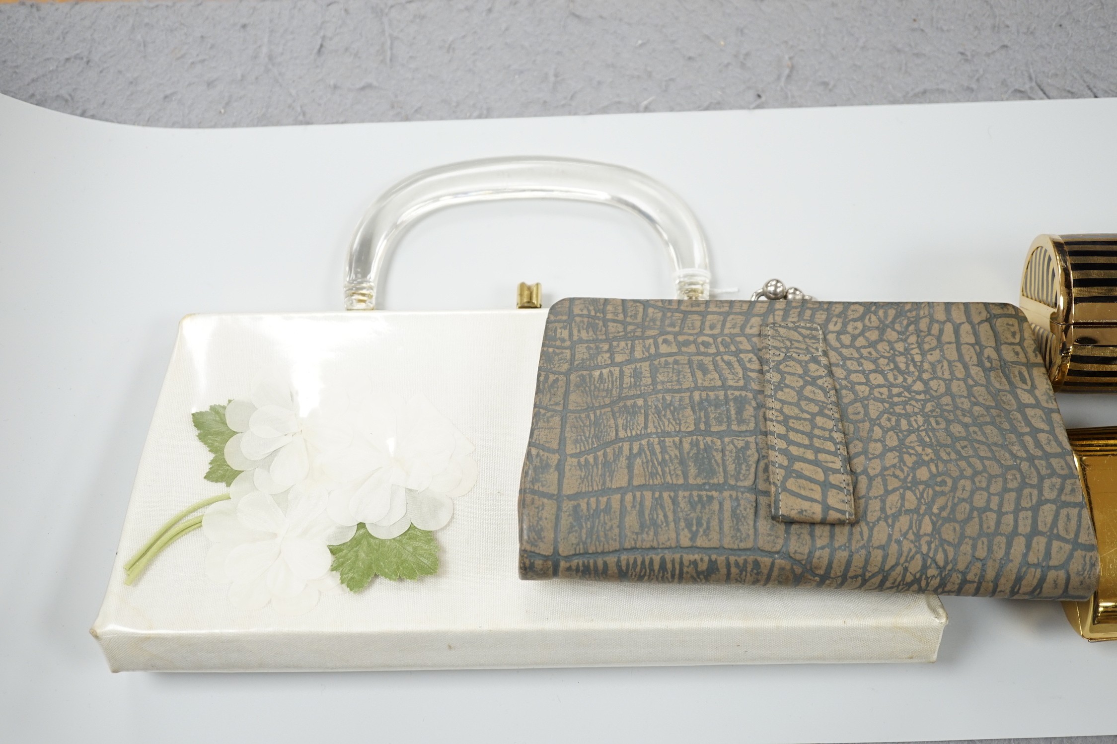 Two 1960's gilt metal ladies evening bags, a metal and wooden bag, a 1950's plastic and fabric bag possibly American, a 1930's faux crocodile clutch bag and a 1930's stripe clutch bag